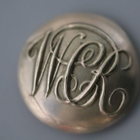Button from West Clare Railway uniform, with letters WCR in relief